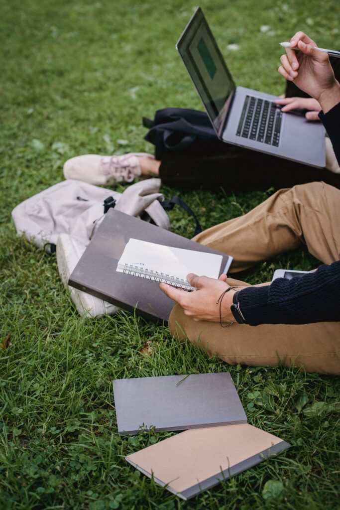 pexels photo 5553071 5553071 From above crop students with laptop and notebooks preparing for exam together while sitting on grass in park