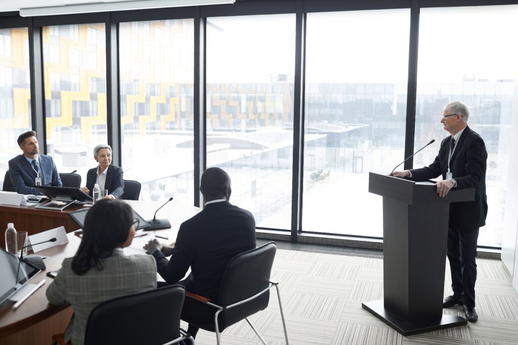 pexels photo 6949934 6949934 Corporate professionals engaged in a formal business meeting in a modern conference room setting.